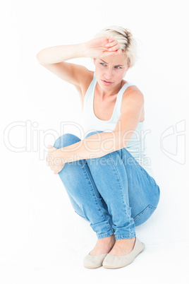 Crouching sad woman holding her hand