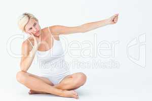 Upset woman sitting on the floor raising her arm