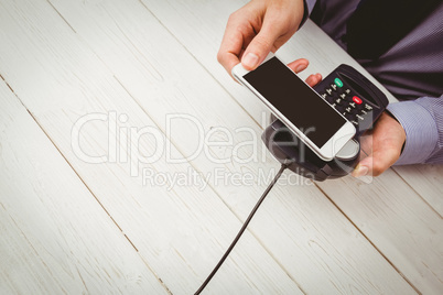 Man using smartphone to express pay