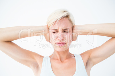 Upset woman covering her ears