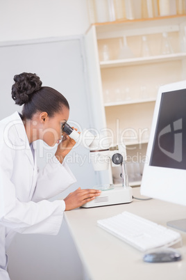 Scientist looking through a microscope