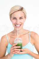Attractive blonde drinking green juice