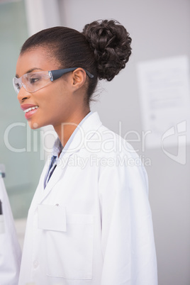 Smiling scientist wearing protective glasses