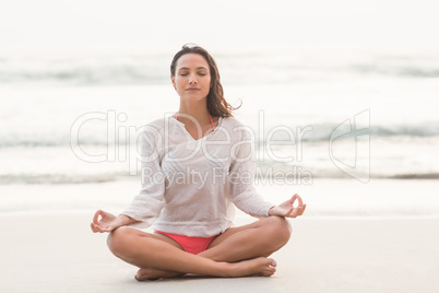 Sporty brunette sitting in lotus pose