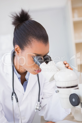 Scientist looking in microscope