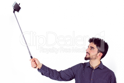 Casual man using a selfie stick