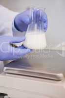 Scientific weighing white liquid in beaker