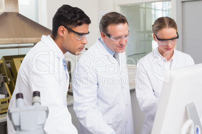 Scientists working attentively with computer