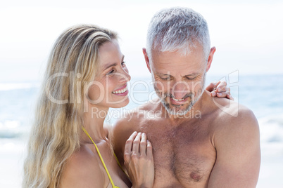 Happy couple standing by the sea and hugging each other