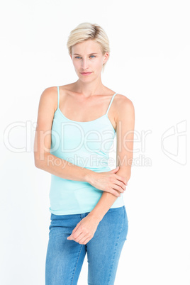 Thoughtful blonde woman holding her arm