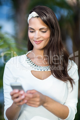 Beautiful brunette using her smartphone