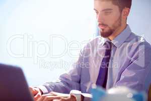 Businessman using laptop at desk