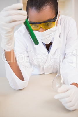 Concentrated scientist analyzing test tube