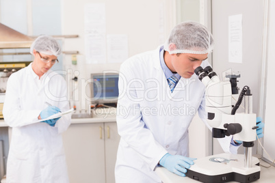 Scientist working attentively with microscope