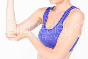 Sporty woman touching her elbow