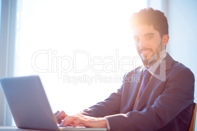 Businessman using laptop at desk