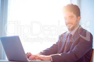 Businessman using laptop at desk