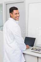 Happy scientist using laptop