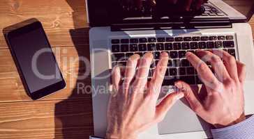 Businessman using laptop at desk