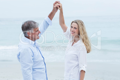 Happy couple dancing by the sea