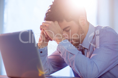 Businessman using laptop at desk