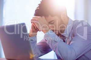 Businessman using laptop at desk