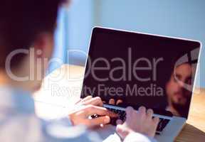 Businessman using laptop at desk