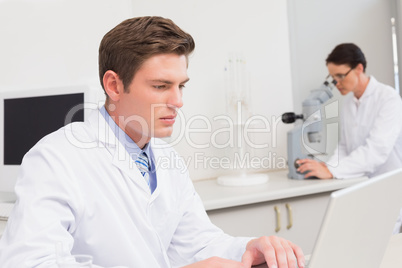 Scientist working attentively with laptop