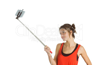 Casual brunette using selfie stick