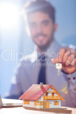 Businessman showing a key