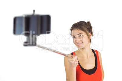 Casual brunette using selfie stick