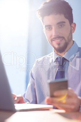 Businessman using laptop at desk