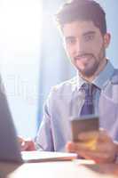 Businessman using laptop at desk