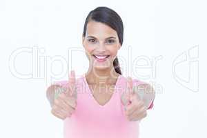Happy woman looking at camera with thumbs up