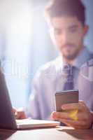 Businessman using laptop at desk