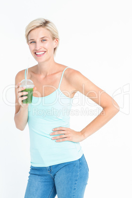 Beautiful woman holding green juice