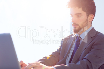 Businessman using laptop at desk