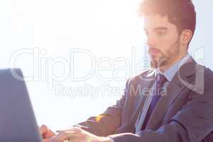 Businessman using laptop at desk