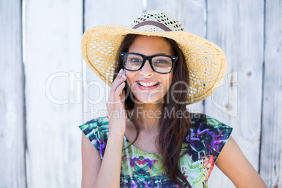 Smiling beautiful brunette speaking on the phone