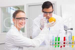 Scientists injecting orange