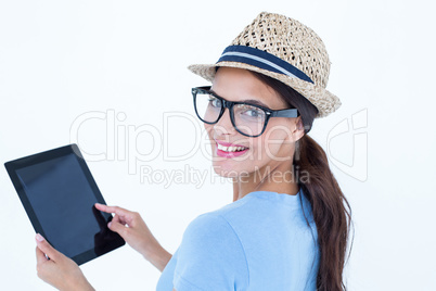 Smiling woman using her tablet looking at camera