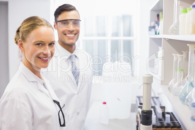 Smiling scientists looking at camera