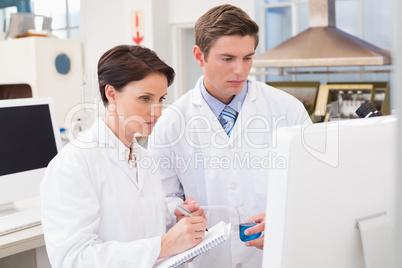 Scientists looking attentively at computer