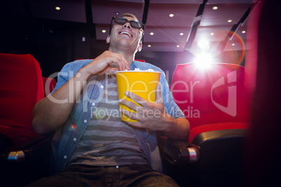 Happy young man watching a 3d film Happy young man watching a 3d film