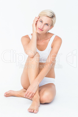Peaceful woman sitting on the floor