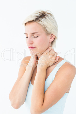 Wincing woman suffering from neck ache