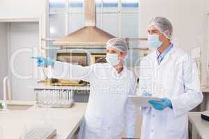 Scientist showing something to her colleague