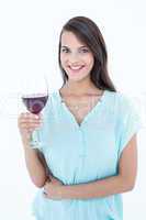 Smiling woman looking at the camera with red wine glass