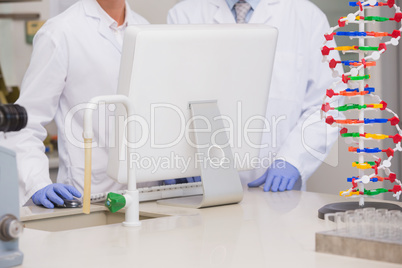 Scientists working on laptop together