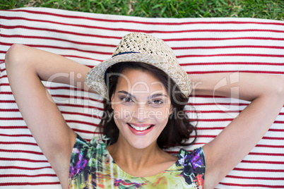 Smiling beautiful brunette lying on the blanket